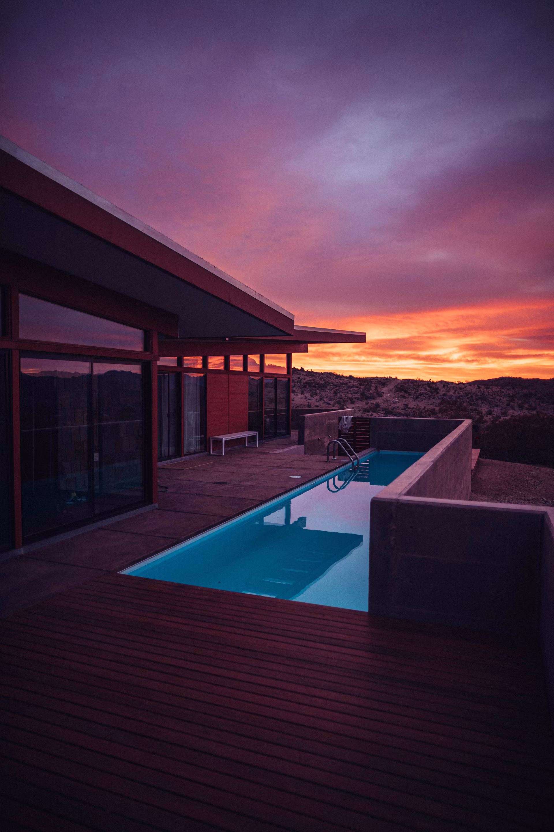 Modern short-term rental villa with a pool at sunset